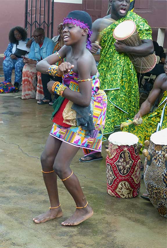 A young female singer and dancer dancing in the court.
