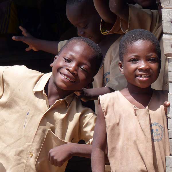 Two little boys outside their village classroom in West Africa.