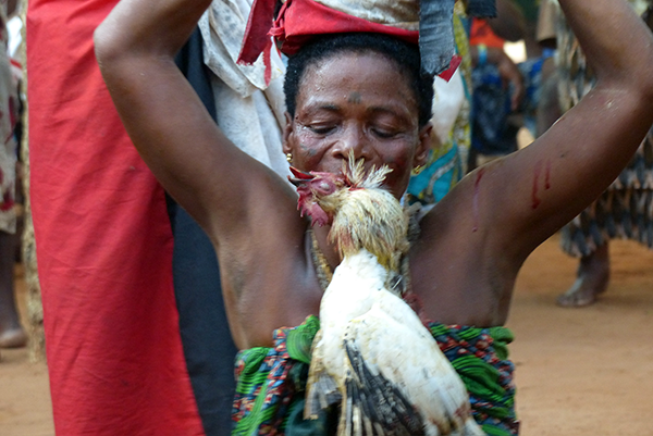 Woman with chicken in mouth